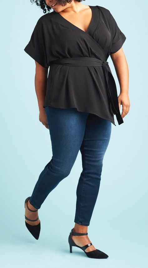 Black v-neck wrap shirt with dark wash skinny jeans and black heels.