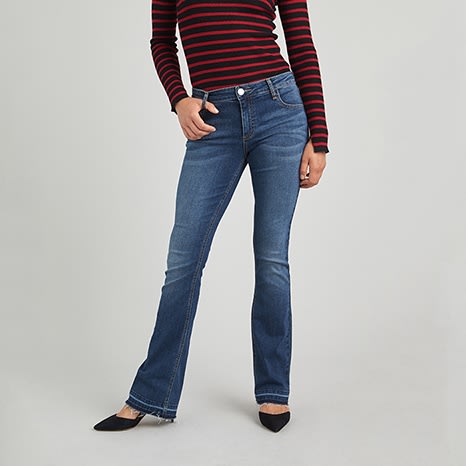 Red and black striped shirt and bootcut jeans with black pointed toe heels.