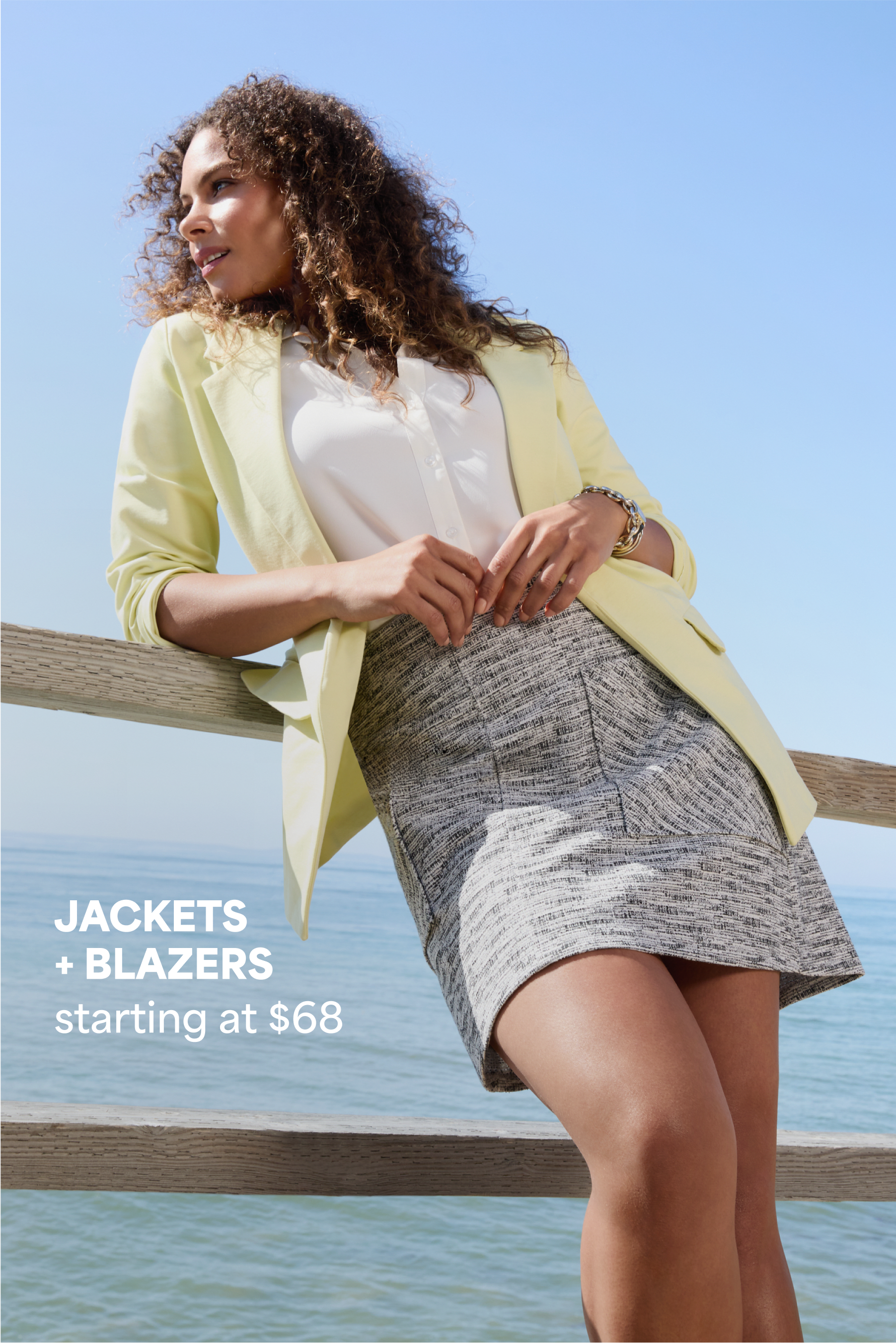 Model wearing Stitch Fix women’s clothes: yellow blazer, white button-down and gray pencil skirt.