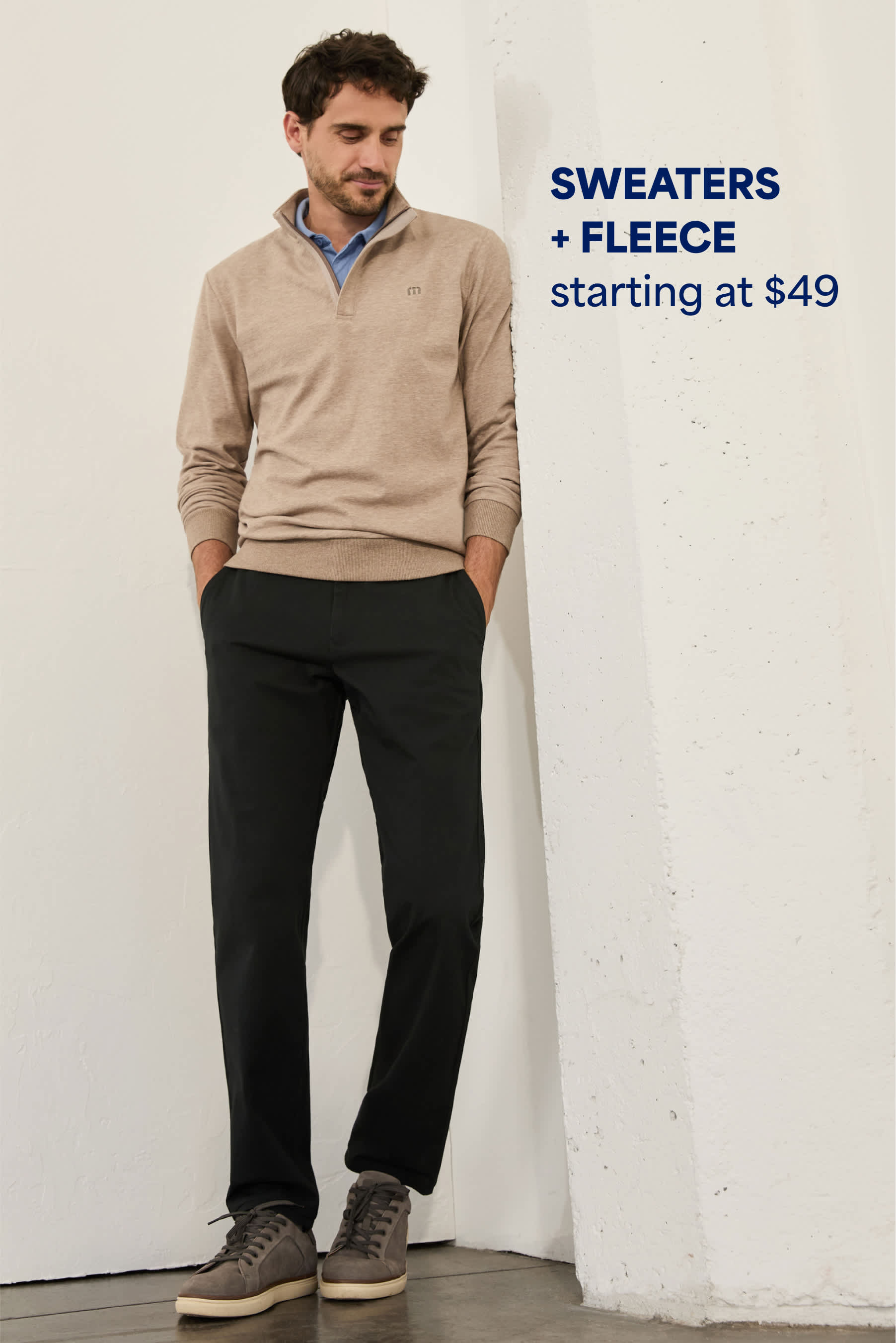 Model wearing Stitch Fix men’s clothes: quarter-zip jacket and black pants. 