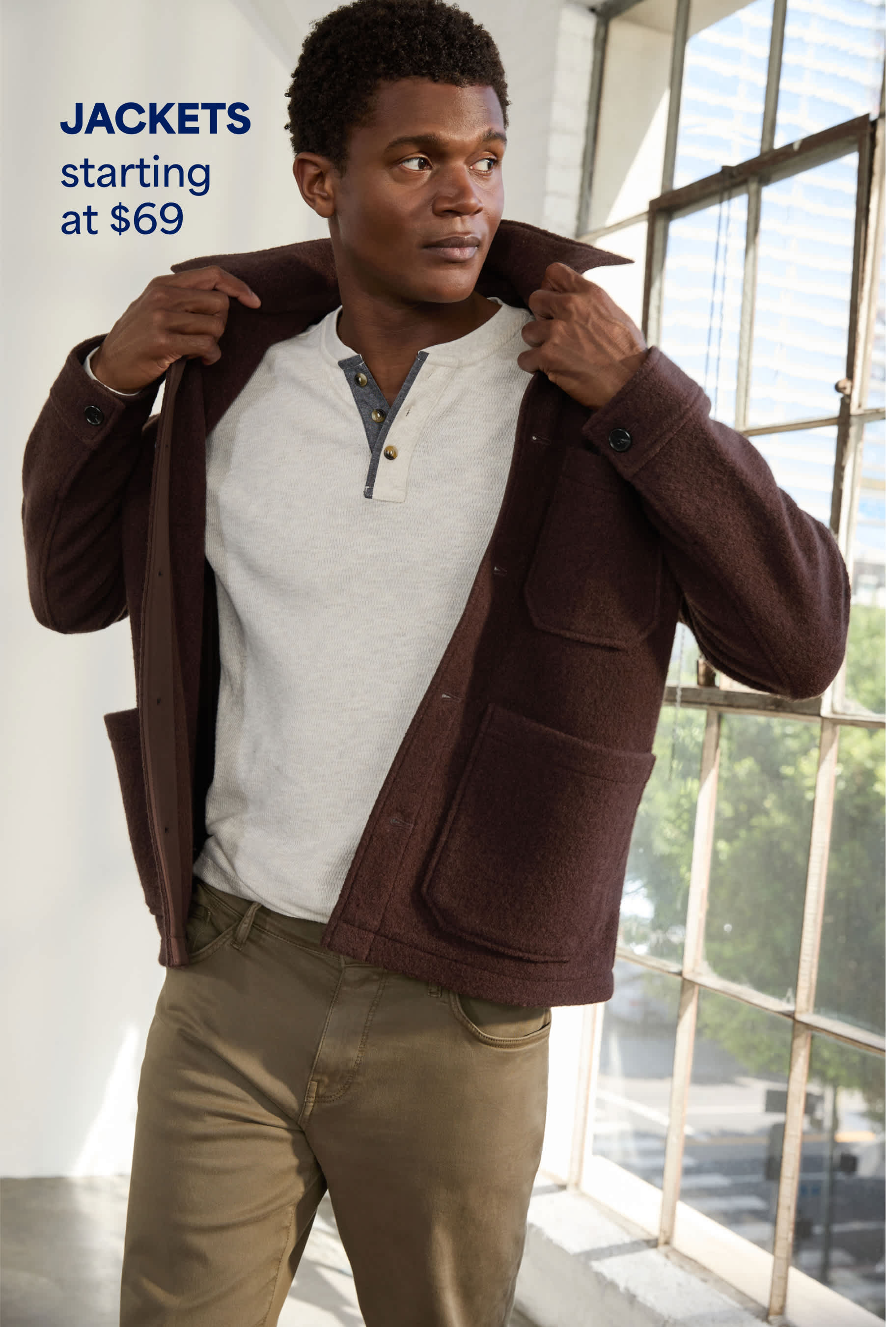 Model wearing Stitch Fix men’s clothes: brown shacket and henley shirt. 