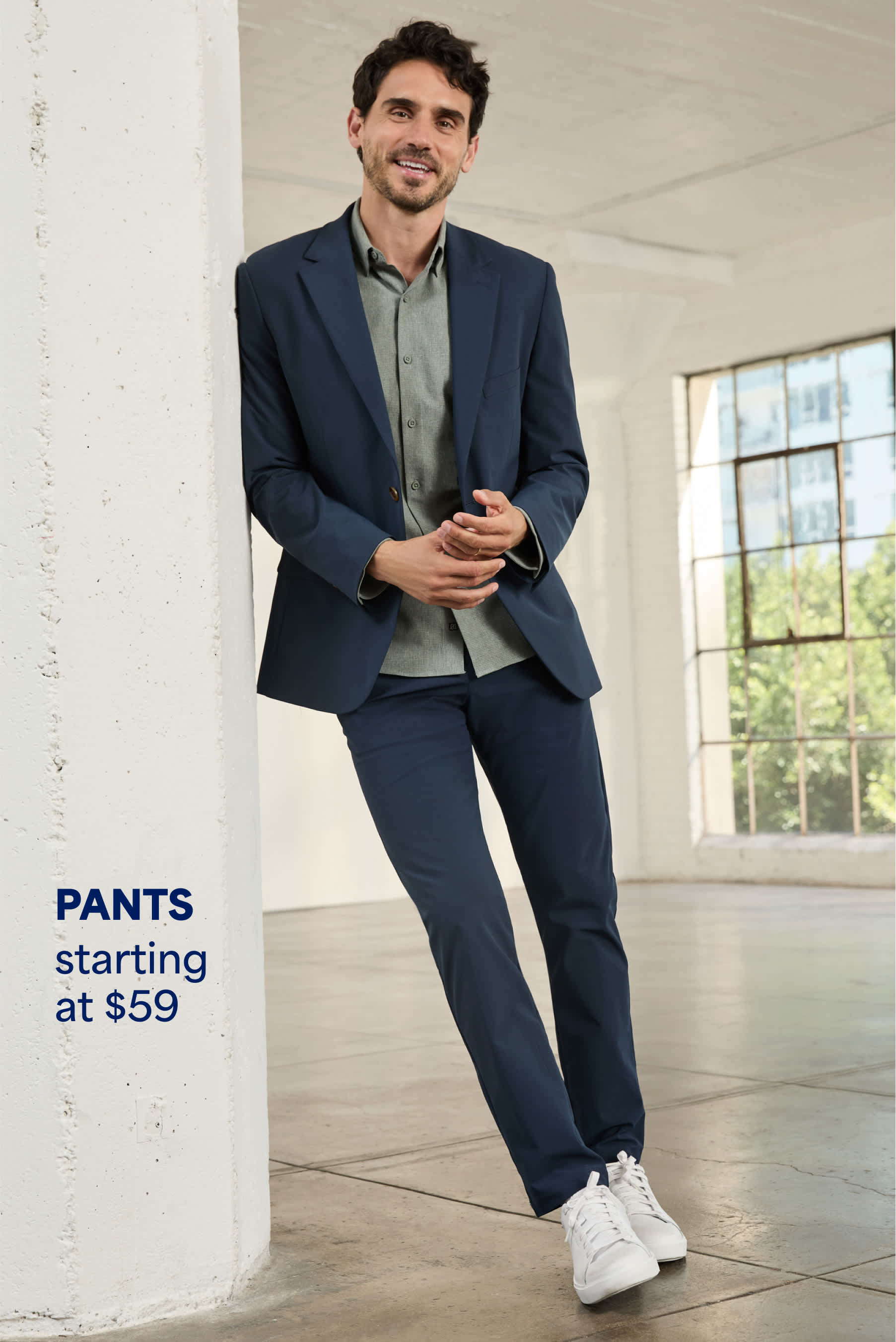 Model wearing Stitch Fix men’s clothes: dark blue pants and a blazer.