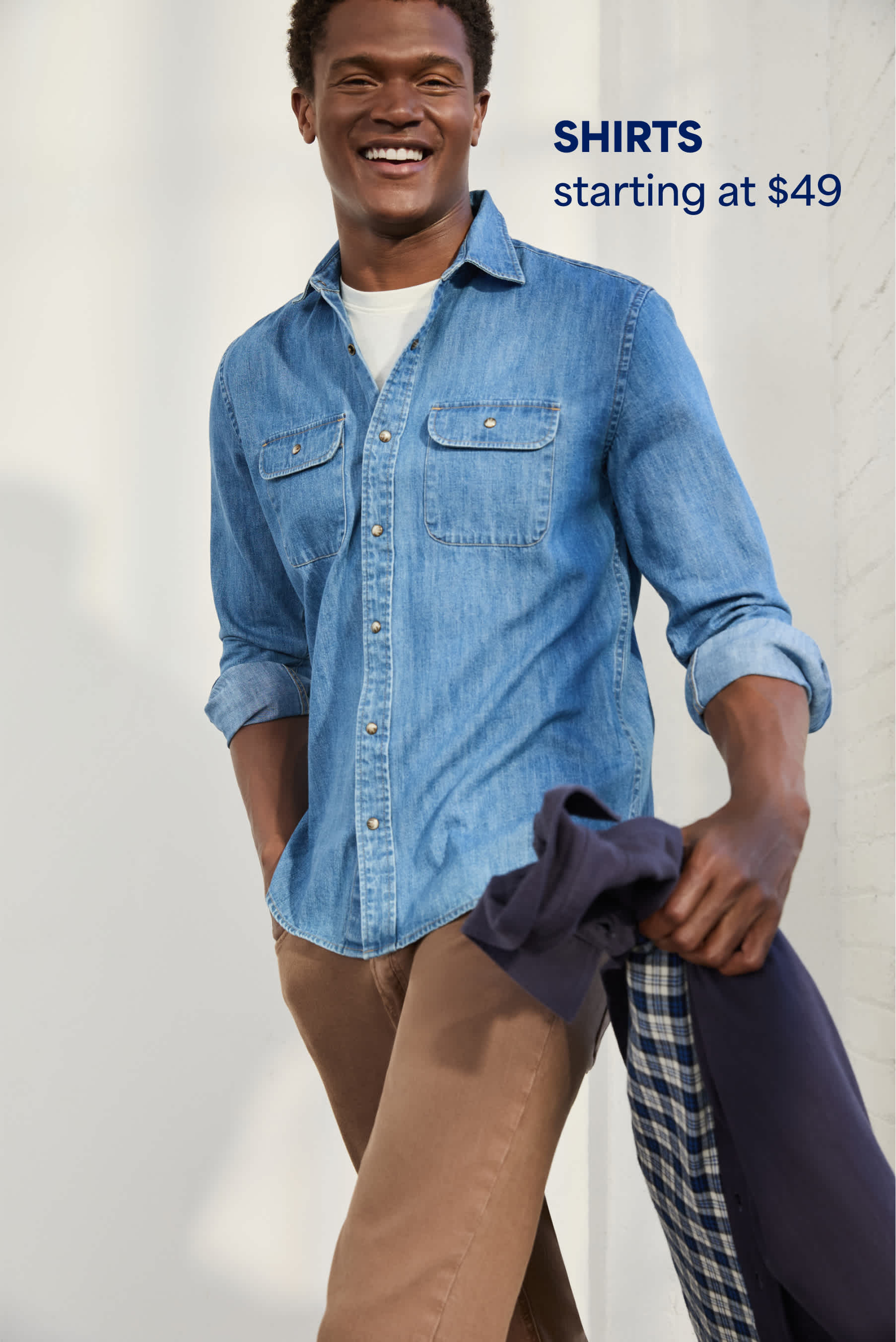 Model wearing Stitch Fix men’s clothes: denim shirt and chinos.