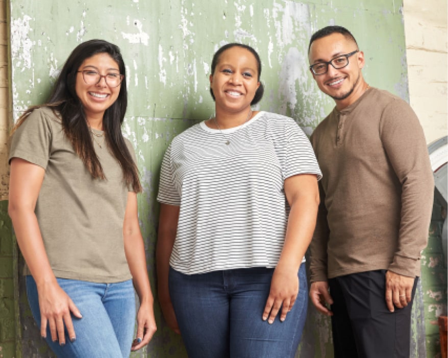 Stitch Fix women’s and men’s employees wearing Mohnton Made tops with denim pants.