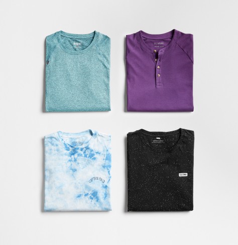 Men’s workout tops in teal, purple, tie-dye and black.