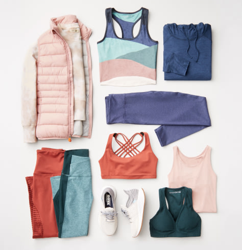 Plus size workout clothing including a pink puffer jacket, and various activewear tops and bottoms, plus sneakers.
