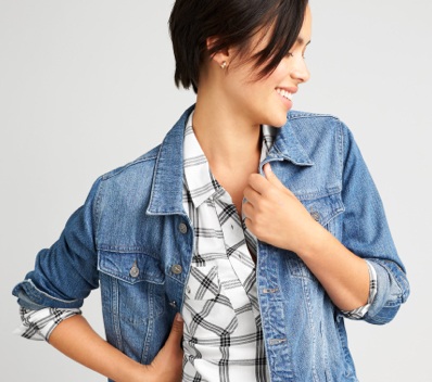 Plaid shirt under a denim jacket.