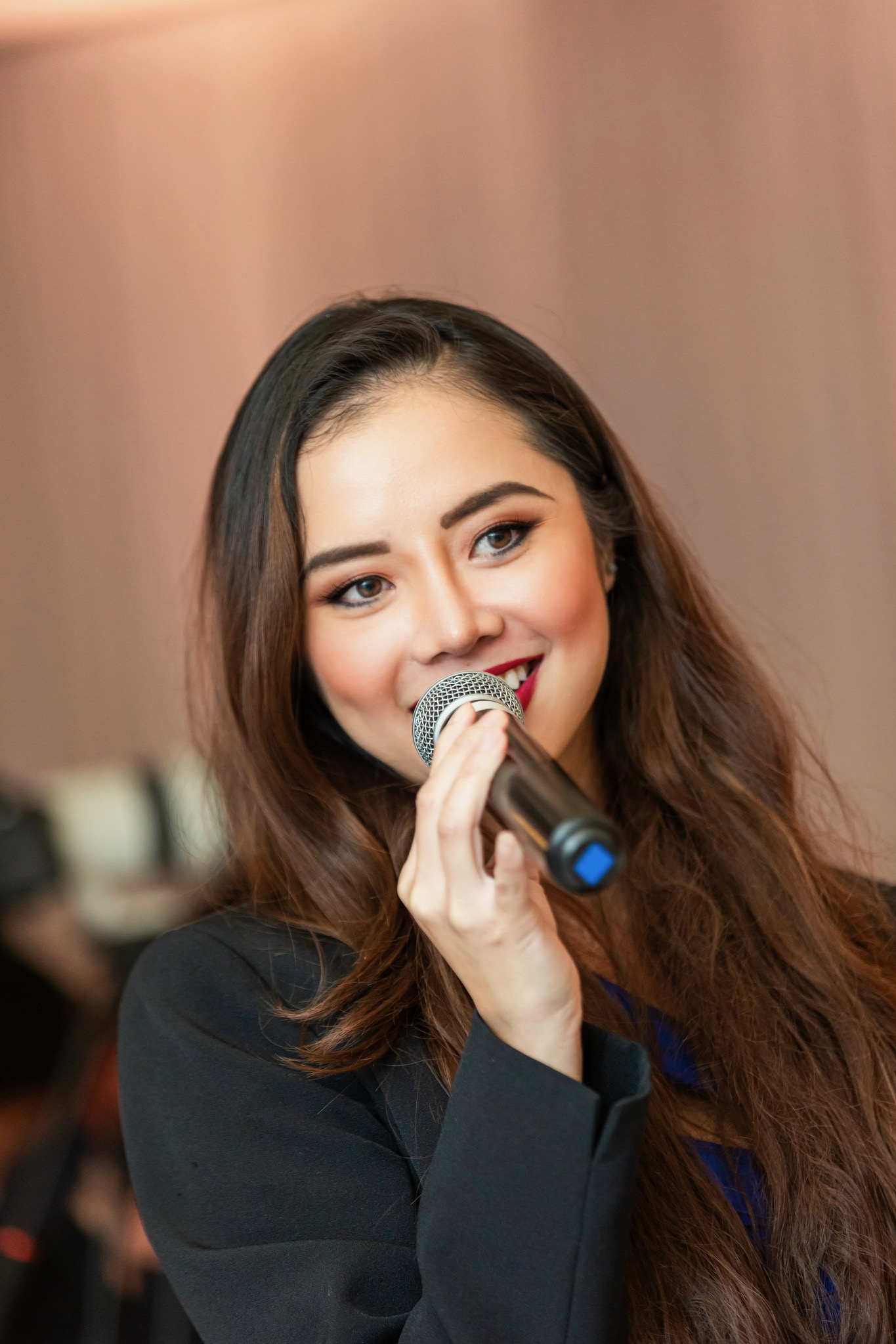 Khanh on the microphone at a Vietnamese wedding reception