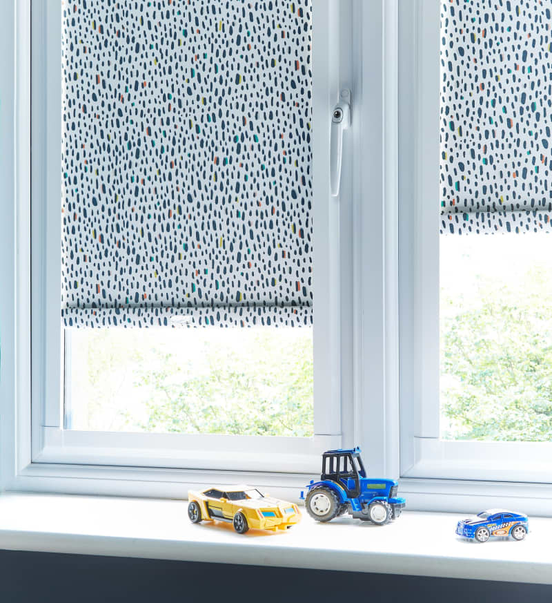 Arena Perfect Fit patterned roller blinds on a uPVC window
