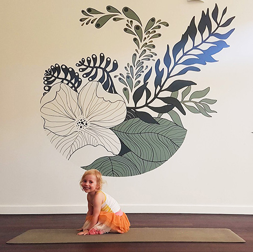 Cute kid being cute on a yoga mat