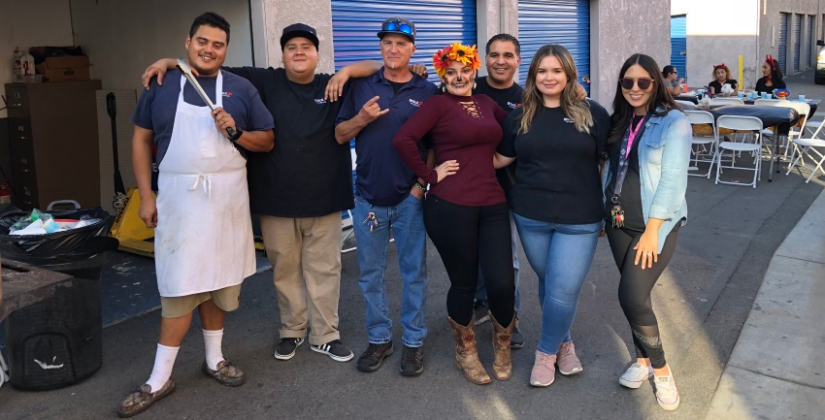 The StaxUP Storage team poses at their Halloween customer event.