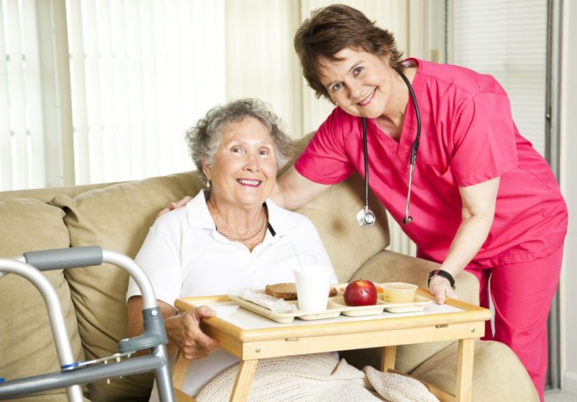 Friendly nurse brings a mean to patient