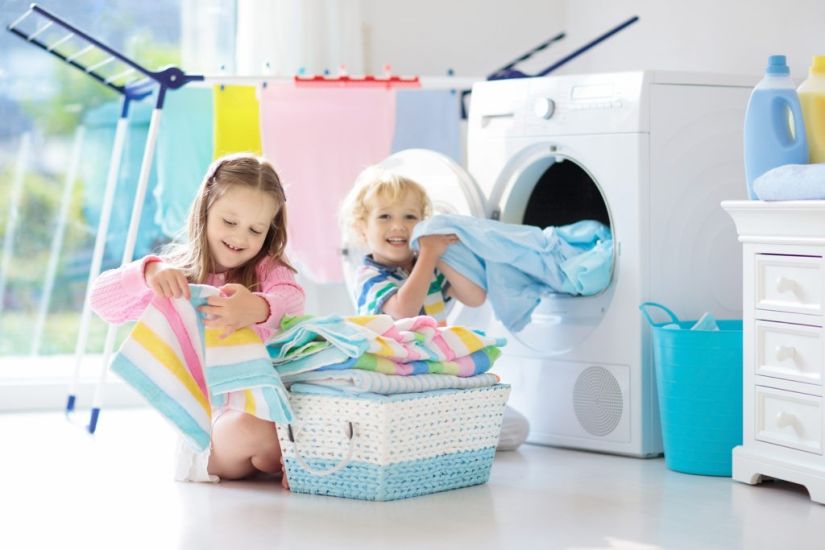 Children in laundry room playing and folding clothes