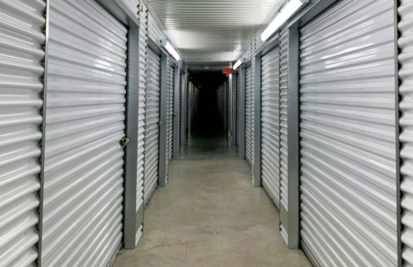 An indoor hallway lined with storage unit doors.