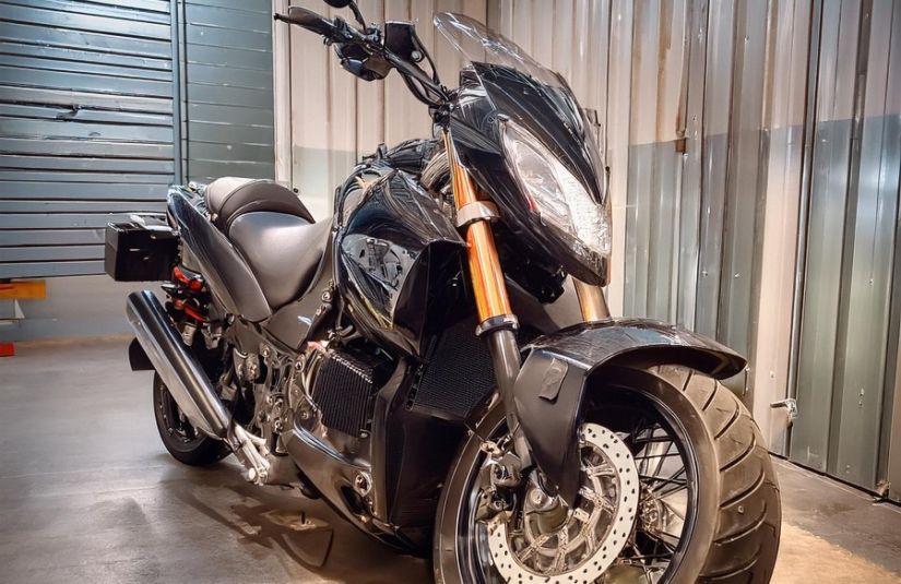 The image shows a motorcycle stored in a self storage unit