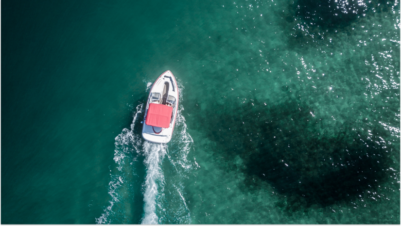 red boat on green blue water