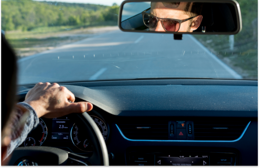 man driving on road