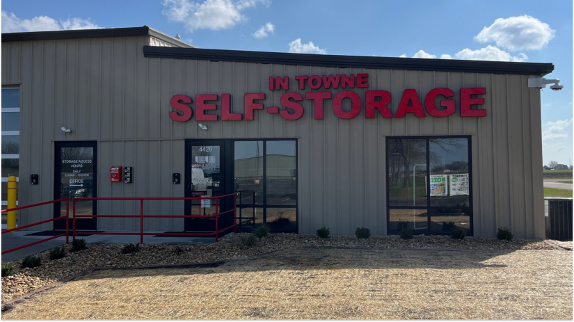Small business owner organizing equipment and inventory in commercial storage unit