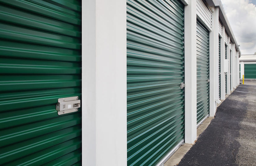 A row of exterior drive-up storage units.