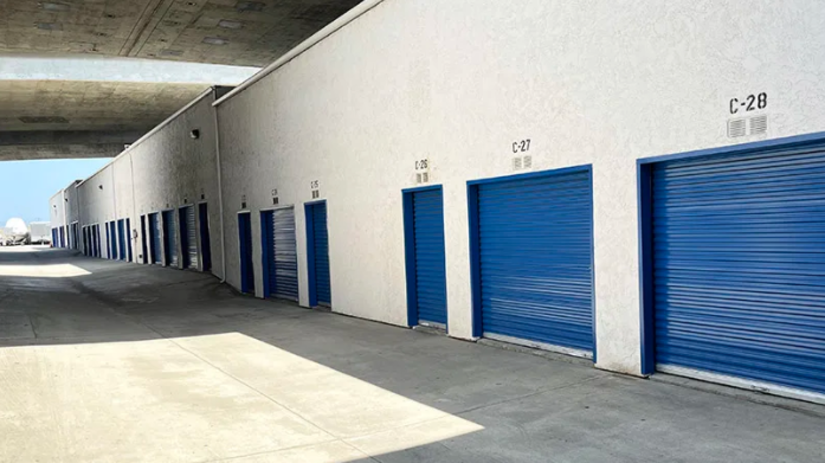 Outdoor row of blue roll-up storage unit doors at a self storage facility in San Diego.