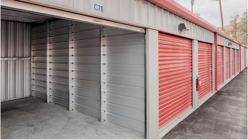 outdoor Stop N Stor storage unit with red roll up storage unit doors and gray inside of storage unit