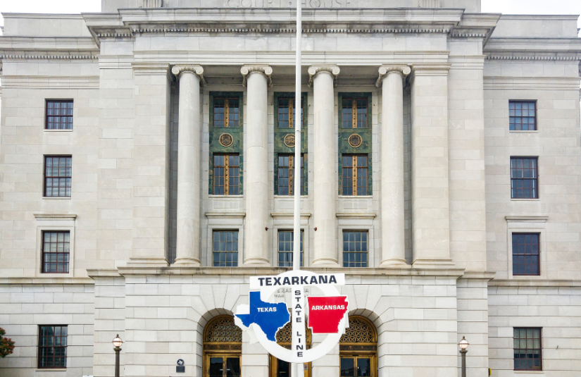 A mailbox on the side of the road. The mailbox is painted with the Texas flag.