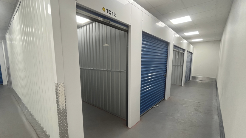 Climate-controlled storage unit with roll-up door open at Store In A Wink in Park City, Kansas
