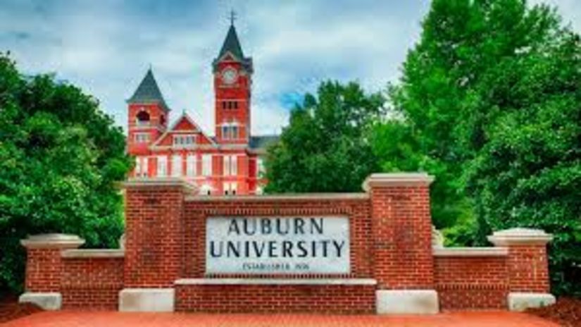 Auburn University Sign with campus in the background