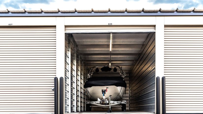 Lakestone Storage secure indoor boat storage unit with covered boat on trailer