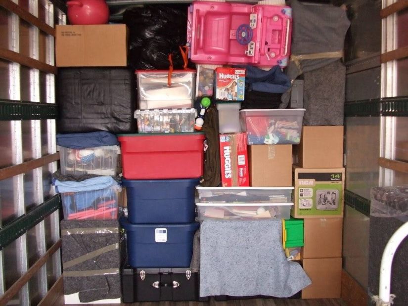 Storage unit with shelves full of boxes and boxes stacked on top of each other
