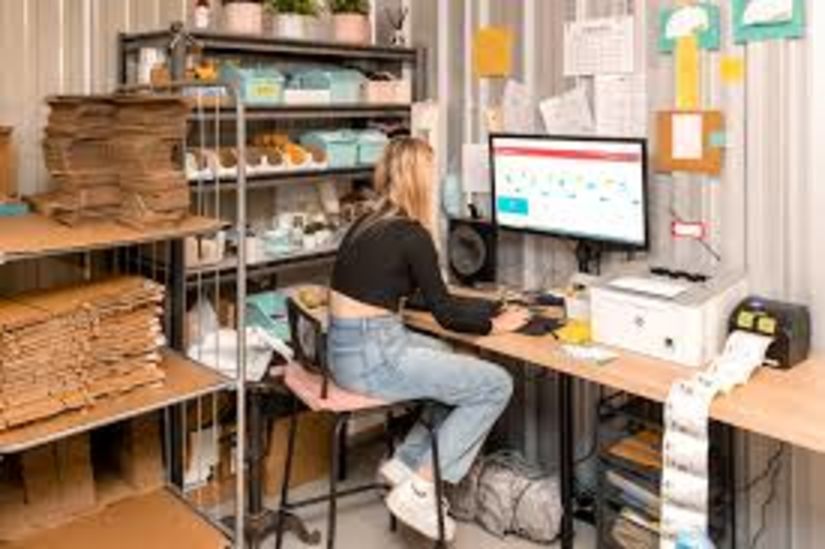 Girl in a storage unit doing work on a computer