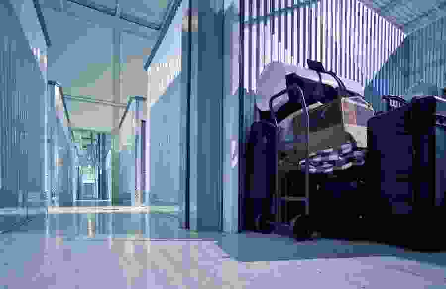 Hallway of storage units and a open storage unit that is full of stuff