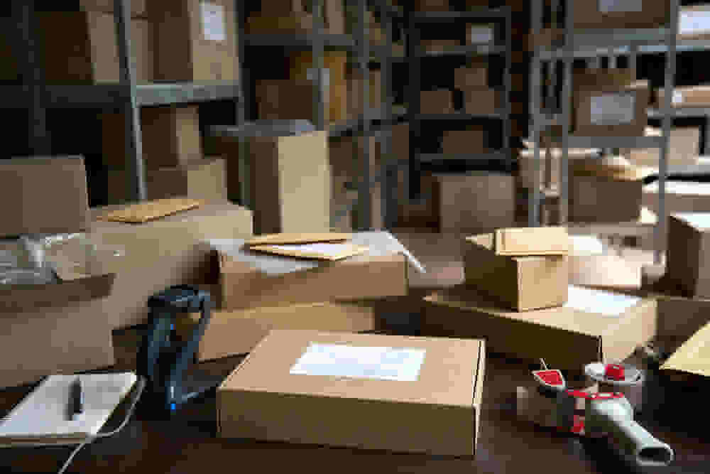 Interior of a large storage unit with inventory for a small business neatly organized on shelves.