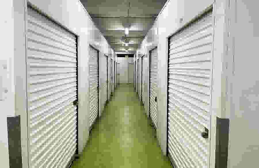 An interior hallway at Ballpark Self Storage, lined with storage units.
