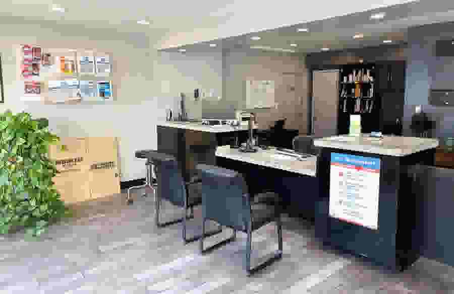 The front office of StaxUP Storage - Chula Vista, with two chairs sitting across from the reception desk.