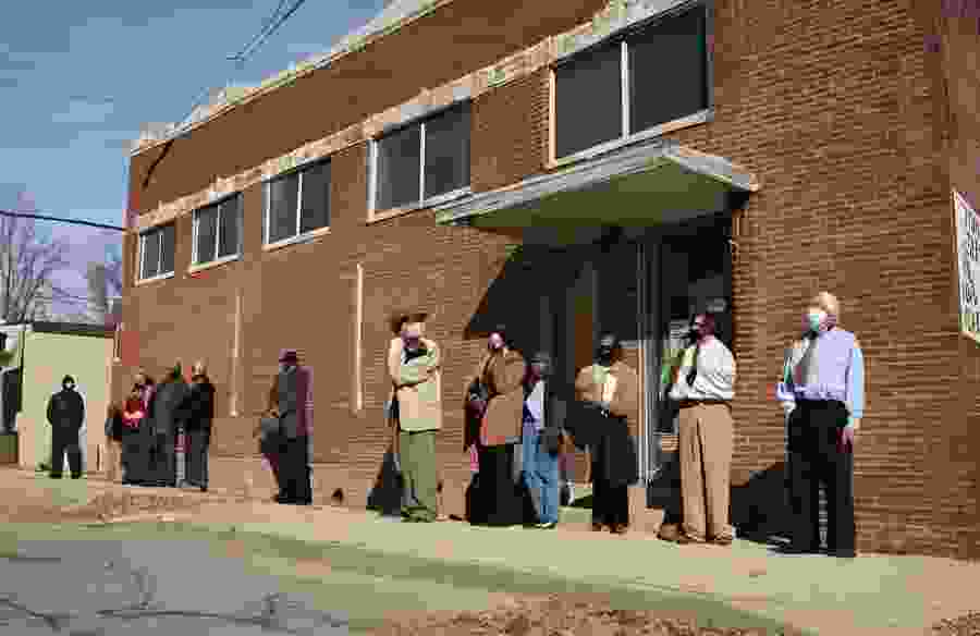 This image shows a line of Van Buren residents waiting for unemployment benefits.