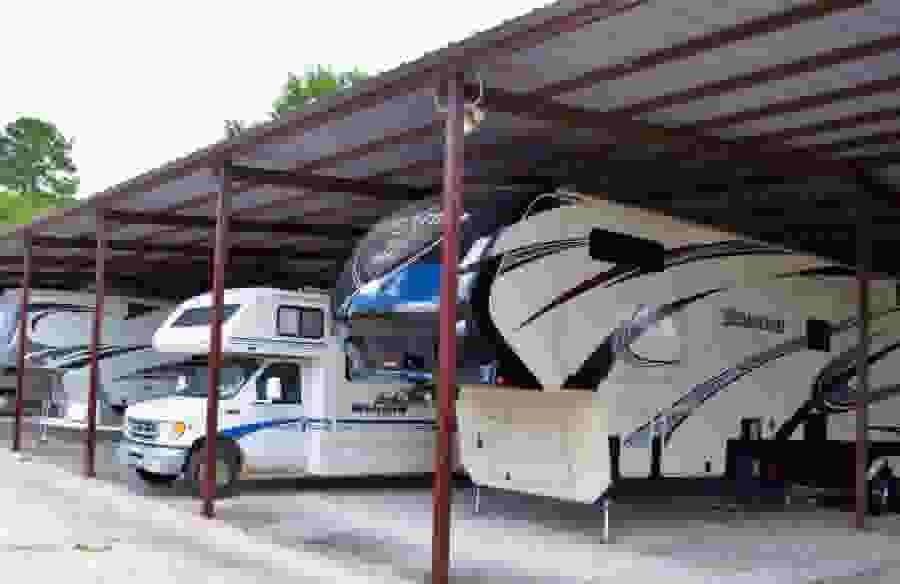 Enclosed parking at Lockaway Storage - Lake Conroe. RVs and travel trailers are parked in the stalls.