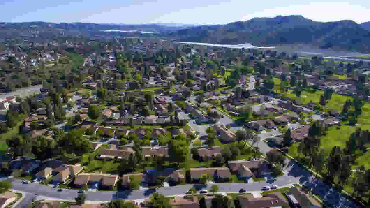 Aerial view of neighborhood with mountains in background