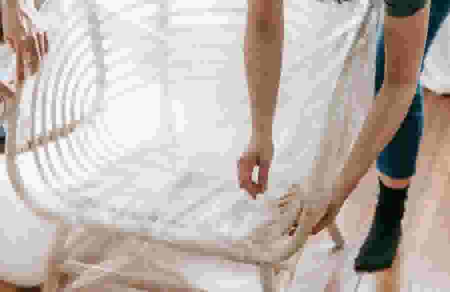 Wrapping a chair in bubble wrap.