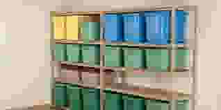 Yellow, green, and blue storage bins on shelves