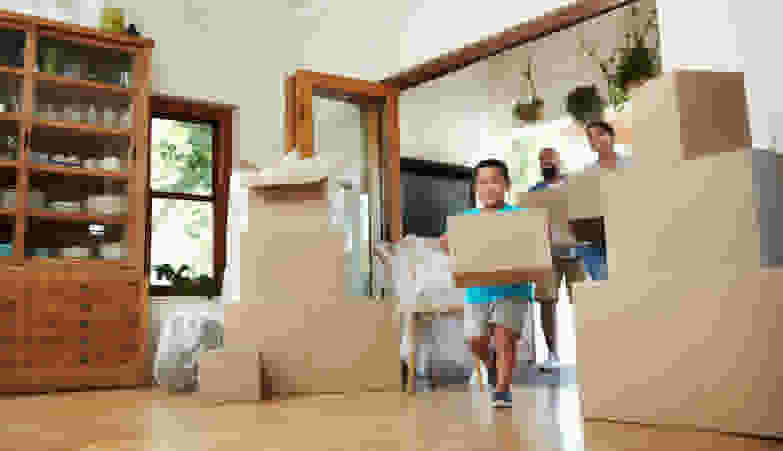 a family packing a house with boxes