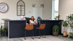 Business owner sitting at self storage rental desk.