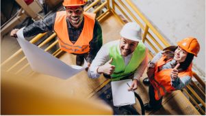 contractor people looking up and smiling on a worksite