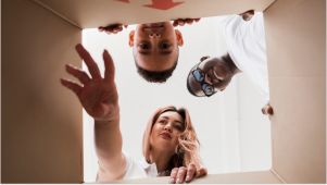 friends looking and reaching into a storage box