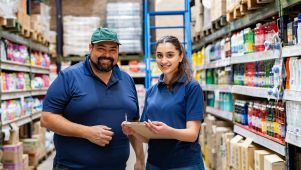 Two employees in storage room