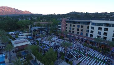 A live music performance outside of Viejas Casino & Resort. It is sunset and the mountains are visible in the background.