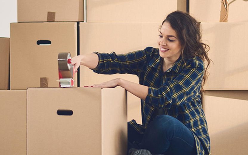 Student preparing moving boxes for a self storage unit