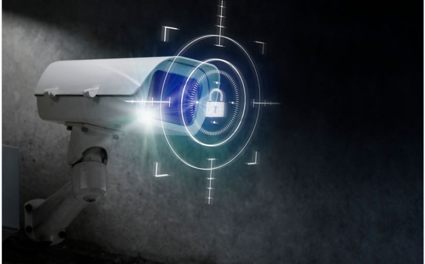white security camera with blue lock symbol