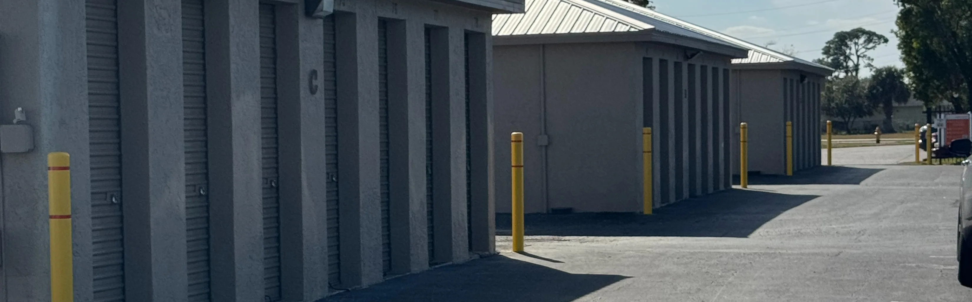 Self Storage buildings with grey walls and roll up doors in Lehigh Acres, Florida