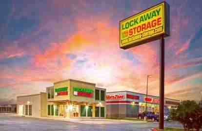 The front of the property. The front office is labeled Lockaway Storage. A sign in front also has Lockaway Storage branding.